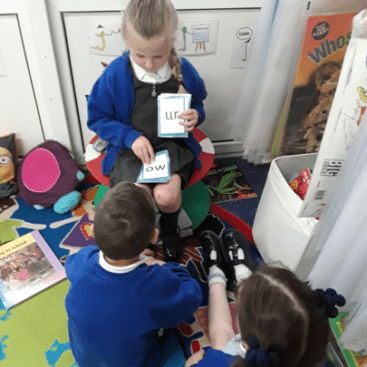 pupils using phonics cards to learn sounds at horton kirby primary eyfs class