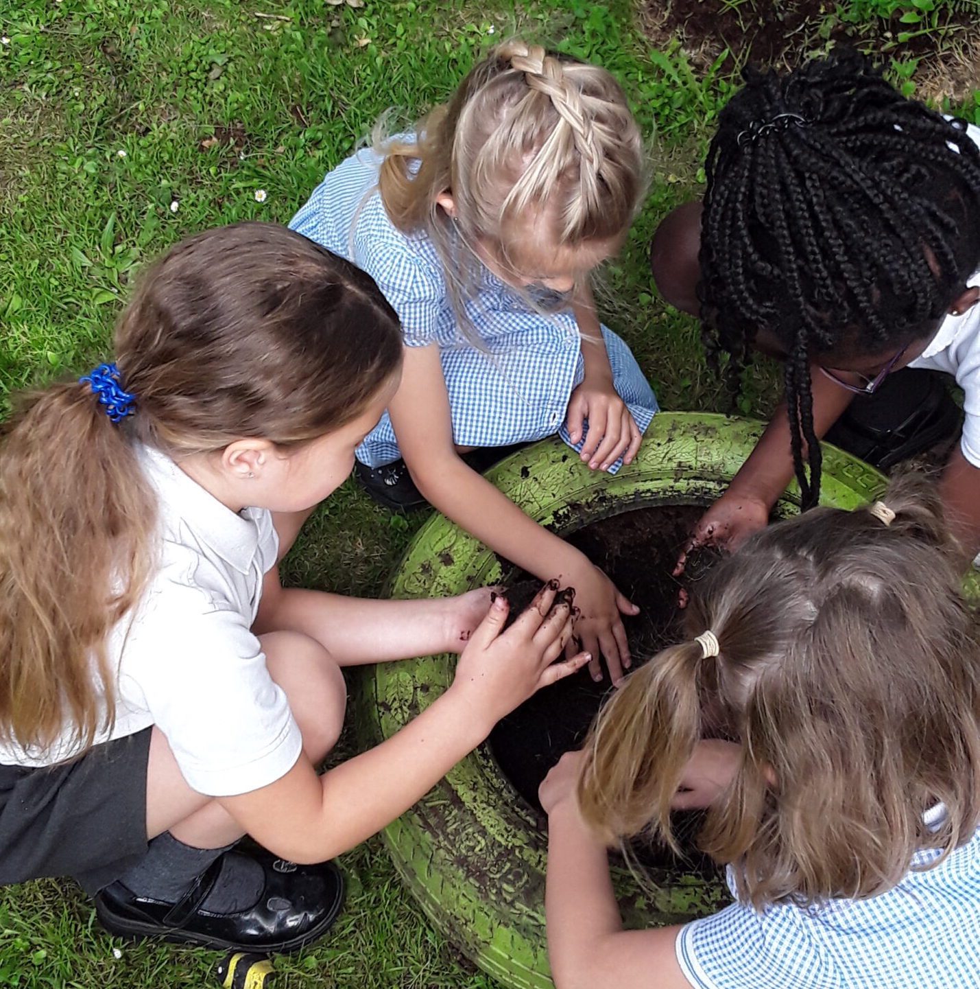pupils playing with dirt on the field as part of their forest school at horton kirby primary school