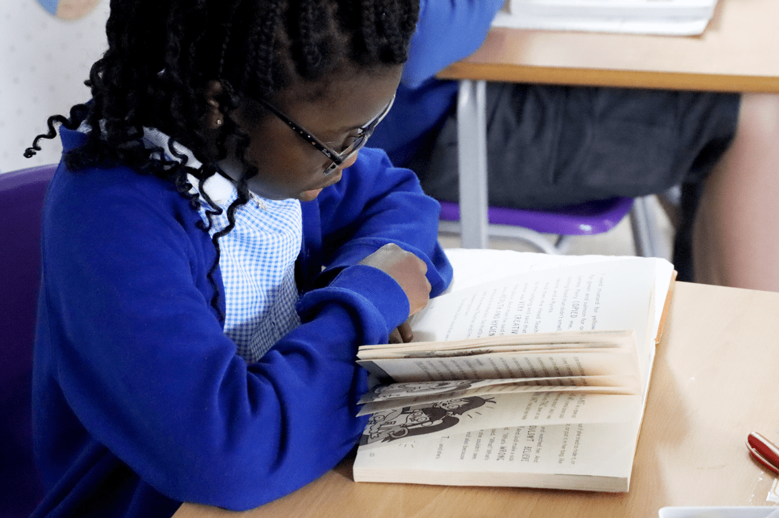 pupil reading a book at horton kirby primary school