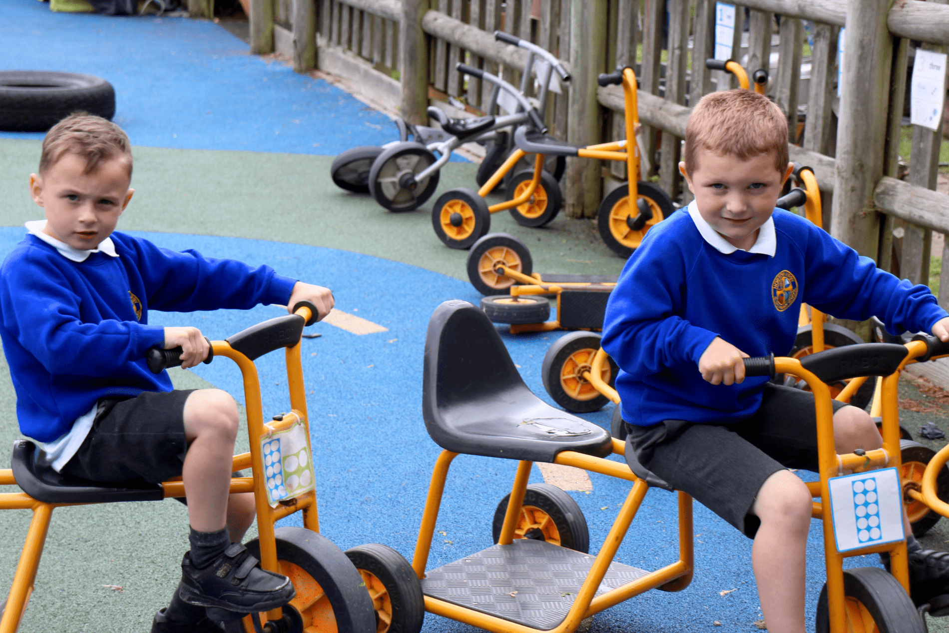 bikes eyfs pupils in EYFS riding on bikes as part of their outdoor play at horton kirby primary school