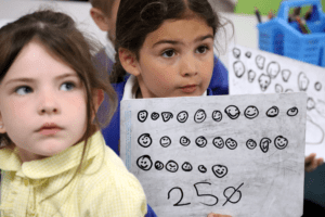 pupil showing whiteboard of counting numbers at horton kirby primary school