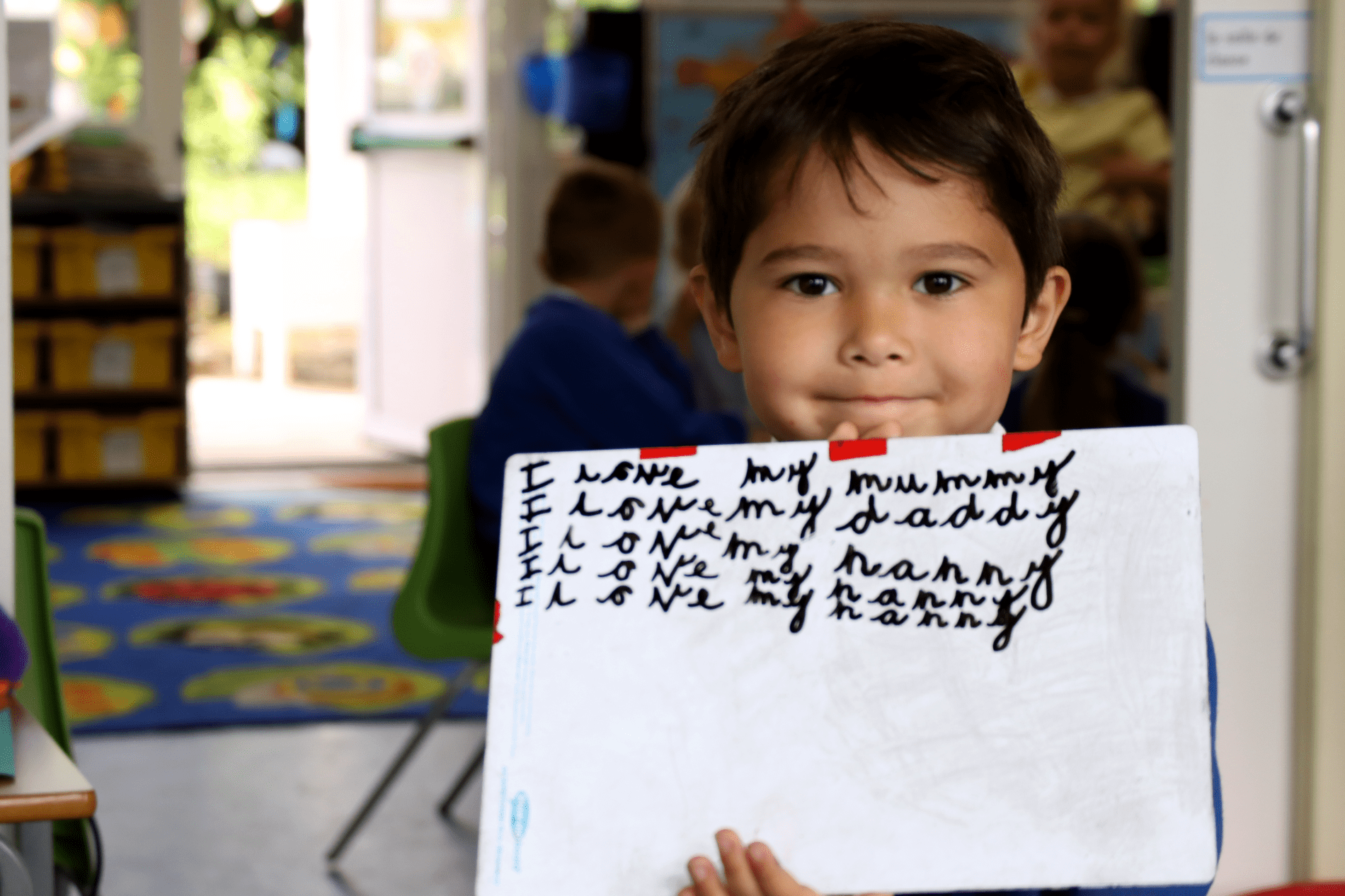 eyfs english pupil showing a whiteboard during an english class at horton kirby primary school