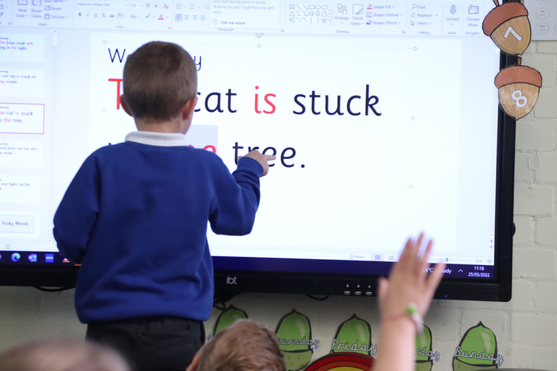 phonics technology pupil pointing at whiteboard during a phonics lesson at horton kirby primary school