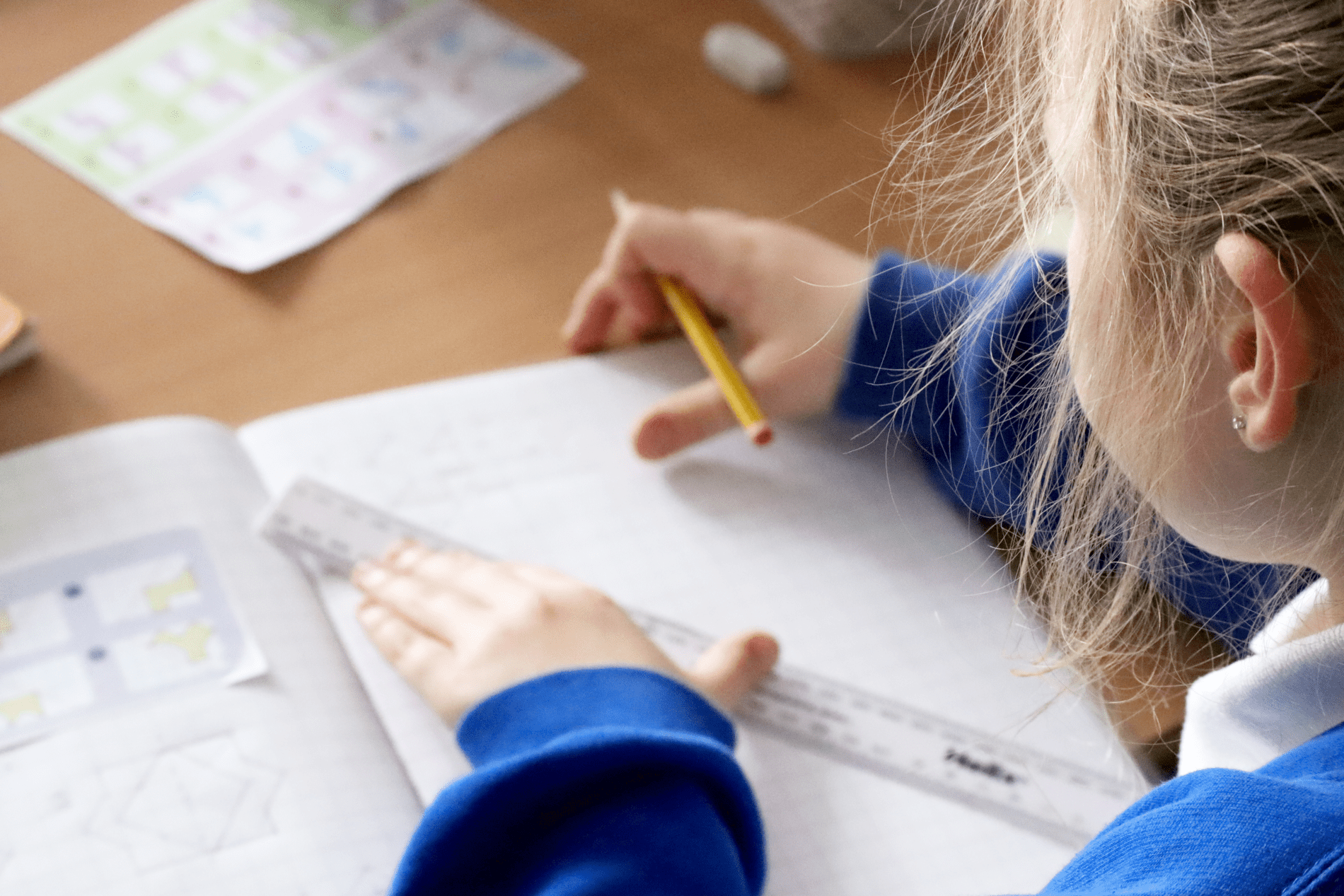 maths workbooks pupil in maths lesson drawing shapes at horton kirby primary school