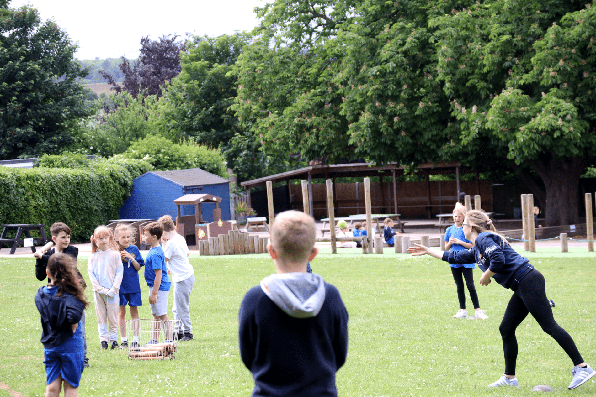 rounders pupils playing rounders with teacher in PE lesson at horton kirby primary school