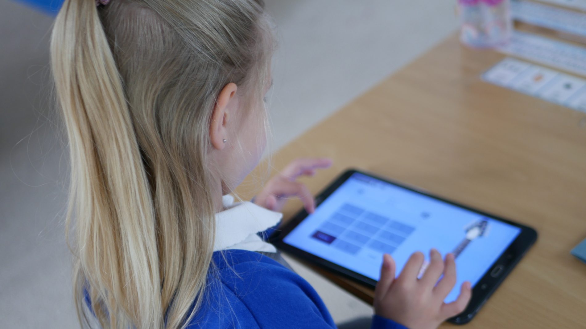 computing pupil on tablet improving their computing skills at horton kirby primary school