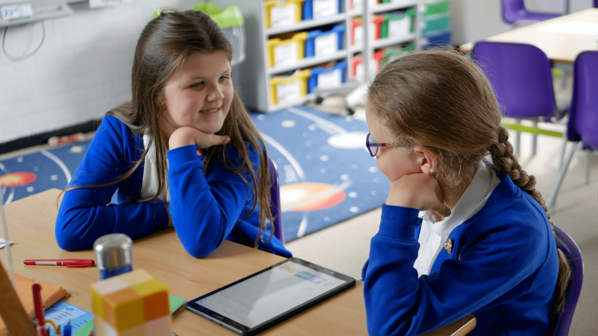 pupils talking two pupils discussing a problem in computing class about Scratch at horton kirby primary school