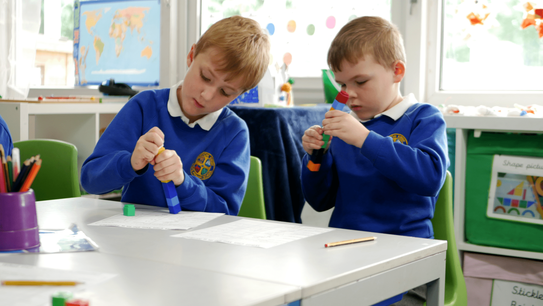 Horton Kirby maths two boys in year 2 at Horton Kirby playing with maths blocks in mathematics lesson