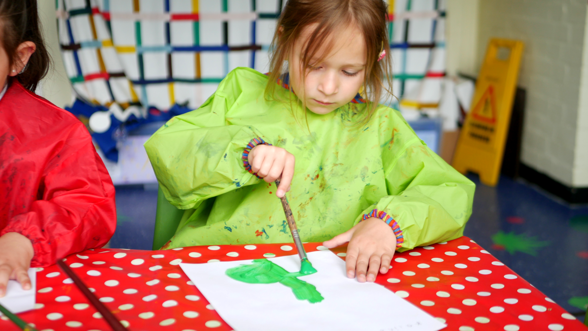 EYFS pupil at horton kirby primary school painting a flower in art class