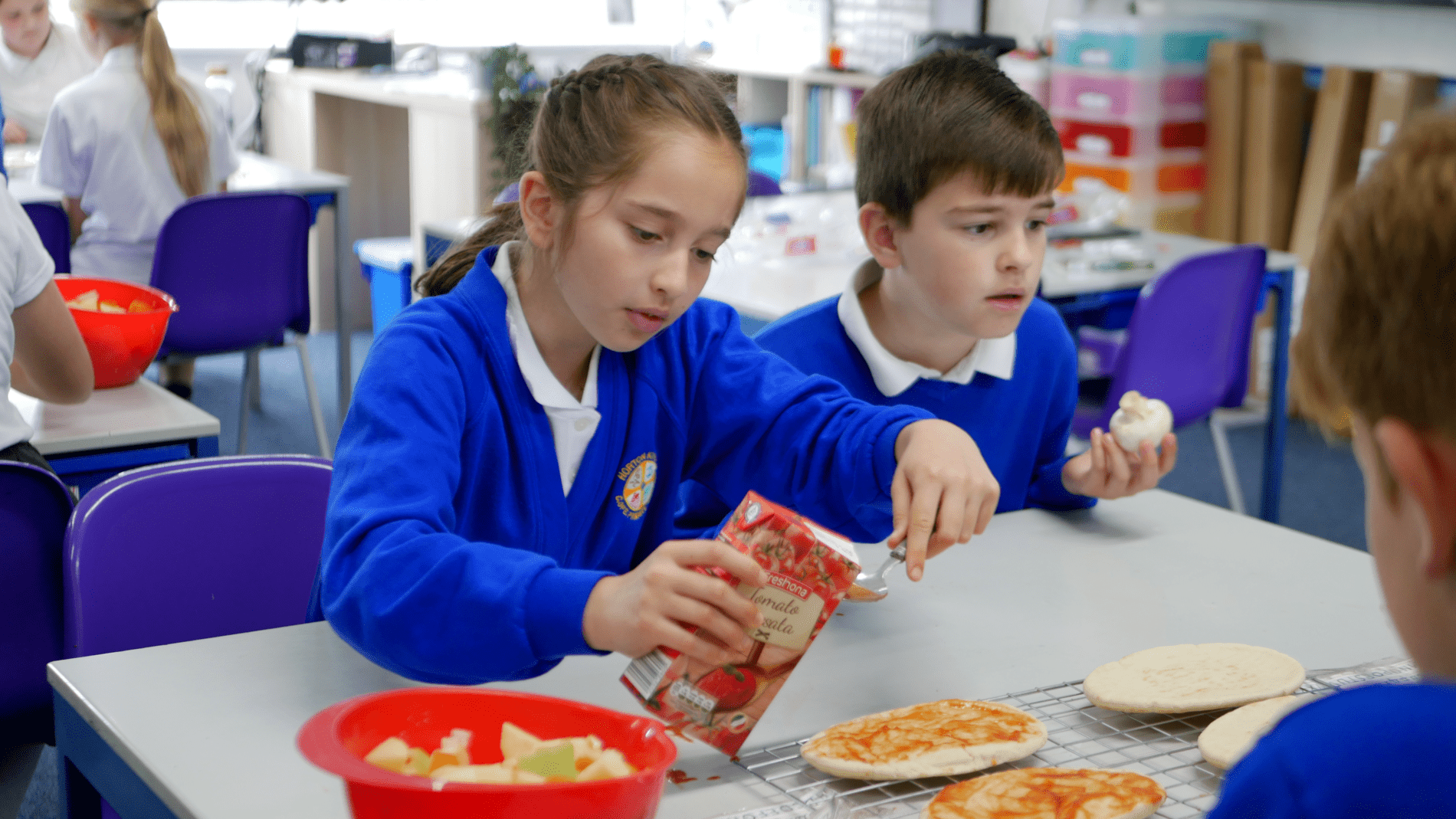 Cooking Dt two pupils cooking in DT making a pizza at horton kirby primary school