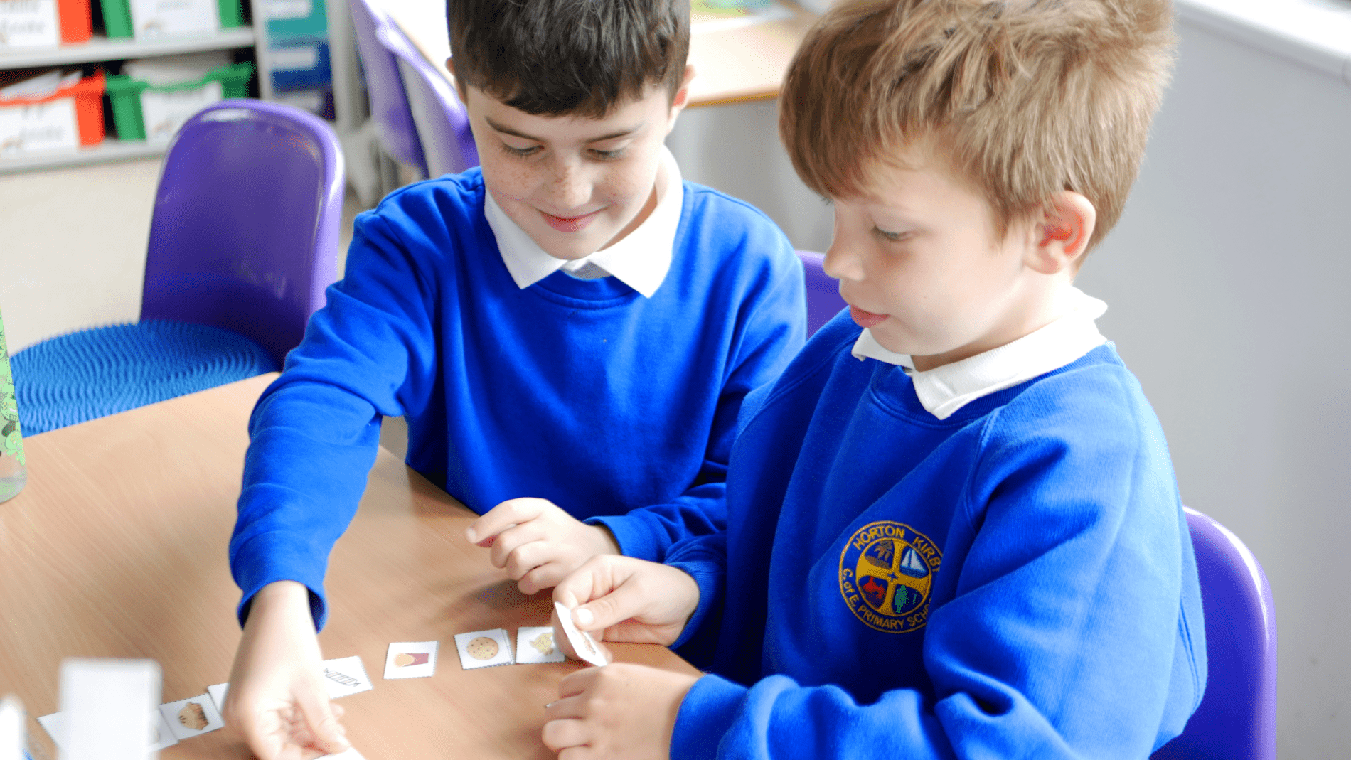 PSHE pupils playing a matching games in PSHE of what is healthy at horton kirby primary school and not healthy