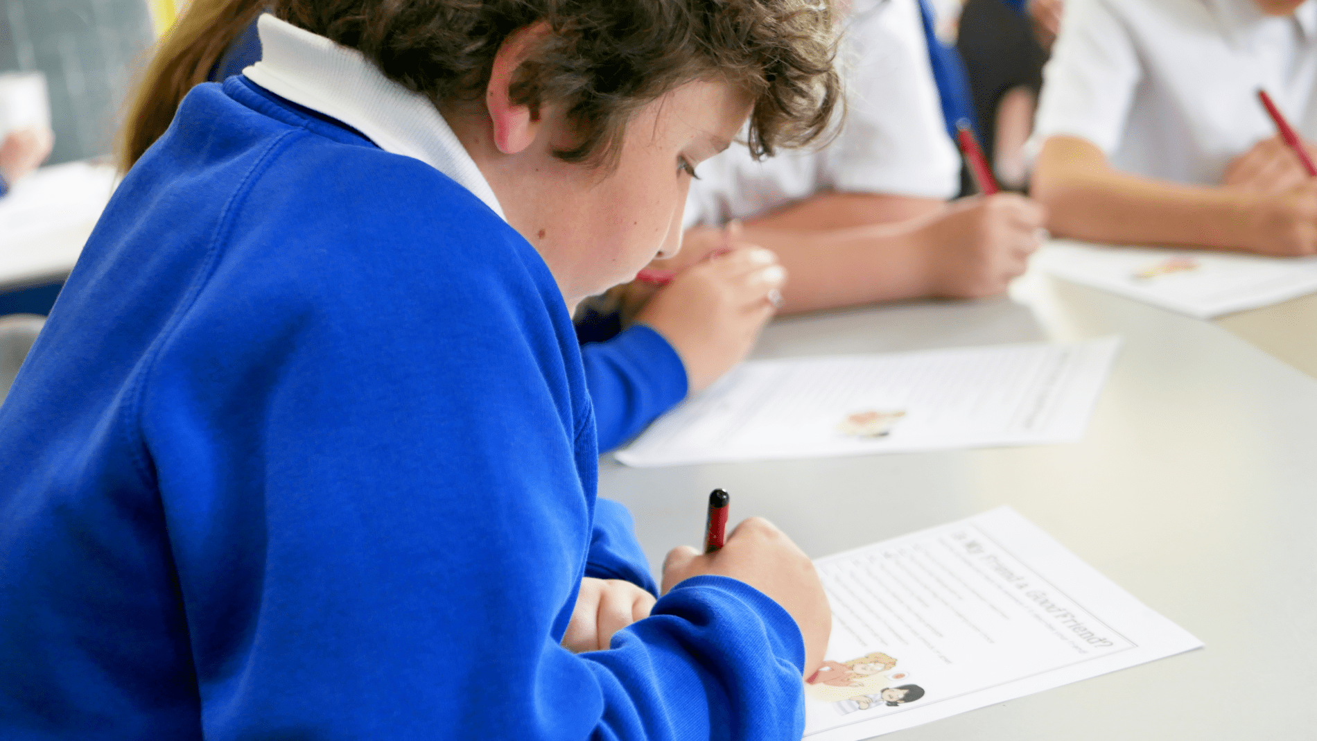 pupil answering questions on a PSHE worksheet at horton kirby primary school