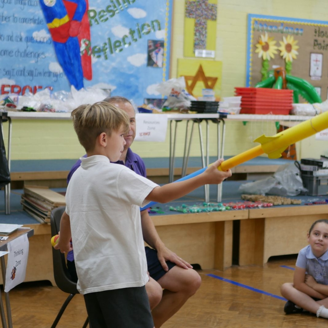 Science rocket pupil releasing a rocket in science class at horton kirby primary school