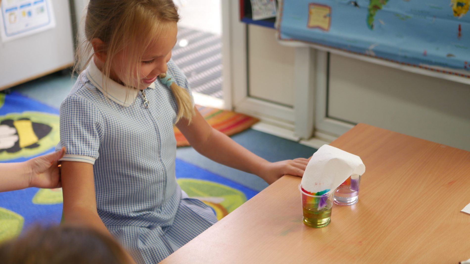 skittles science girl experimenting with water and skittles during their science day at horton kirby primary school