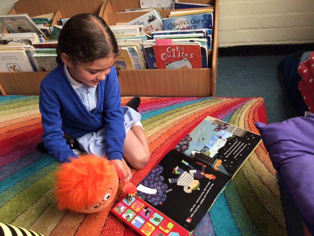 pupil reading in a reading corner in year 1 classroom