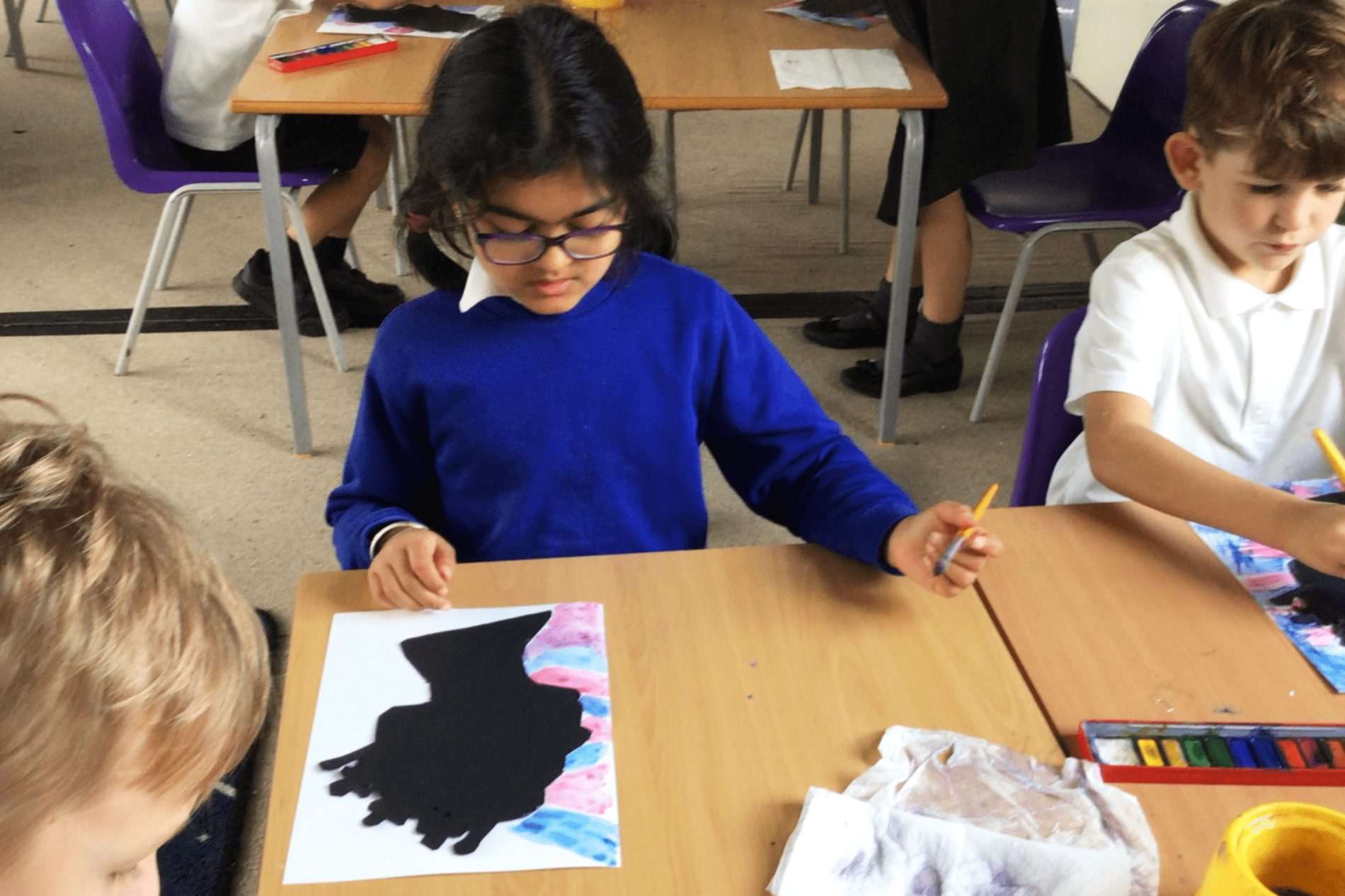 girl drawing a silhouette of the queen in art class at horton kirby primary school