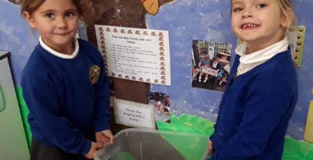 two pupils from horton kirby cofe primary school receiving two giant african snails from aletheia academies trust