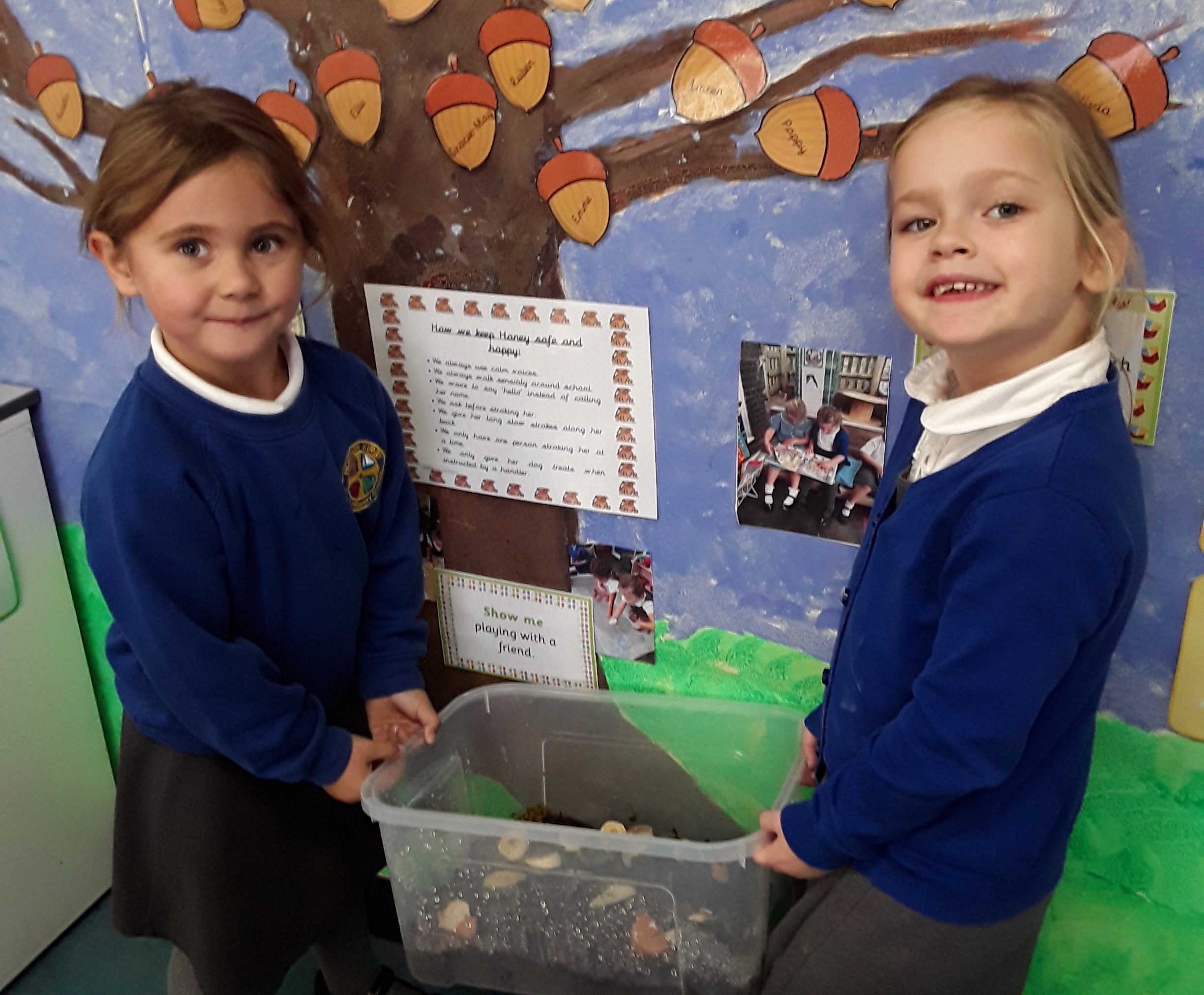 two pupils from horton kirby cofe primary school receiving two giant african snails from aletheia academies trust